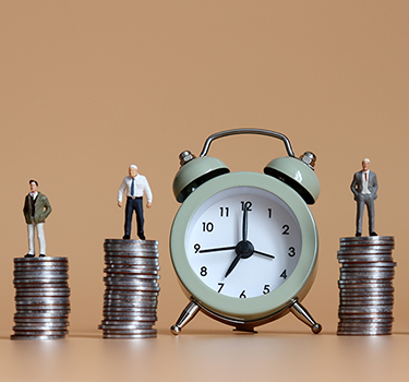 alarm clock with stacks of coins