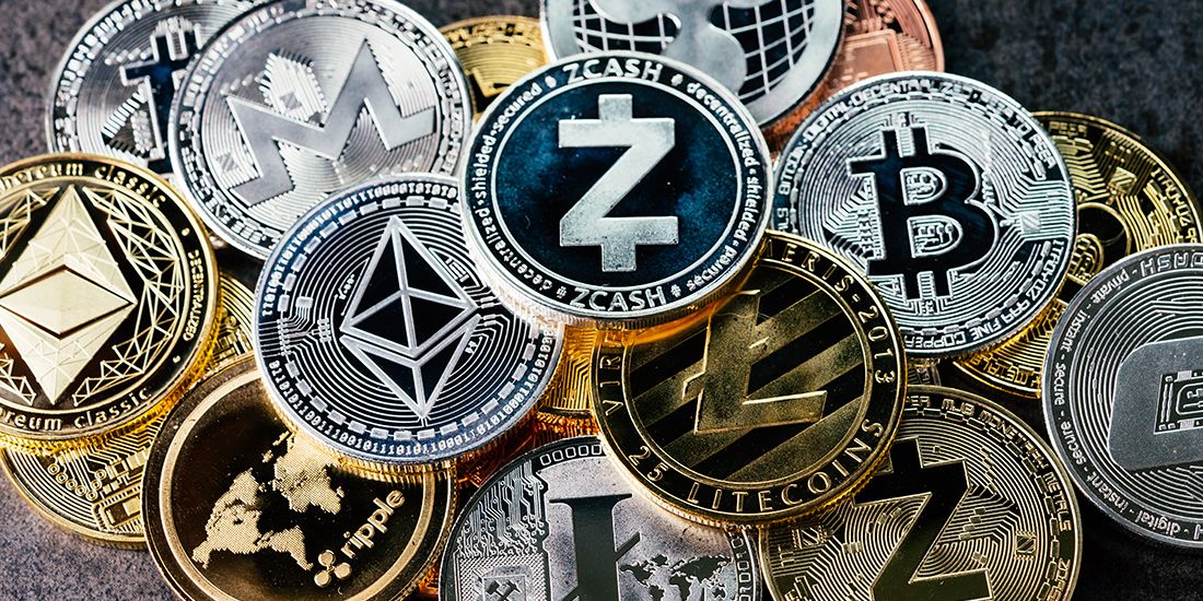 Bitcoin, Peercoin, Litecoin, Dogecoin, Auroracoin, Namecoin, Ethereum, Ripple, Stellar, NEO, Cardano, IOTA (Internet of Things Application) Bit coins scattered on a counter