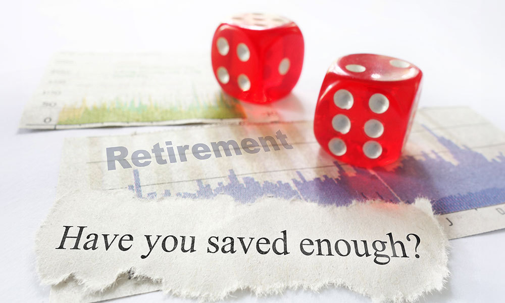 Dice on a piece of paper asking if you have saved enough for retirement
