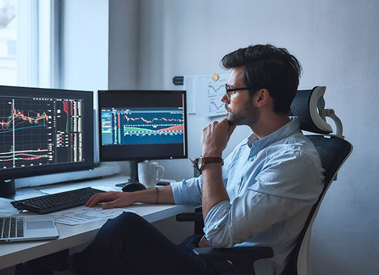 person watching stock market graphs for investment