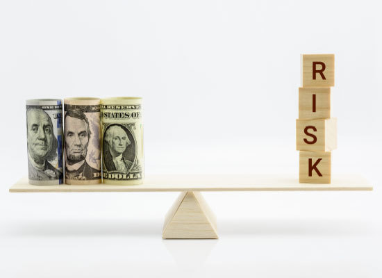 a balance scale with money on one end and risk on the other