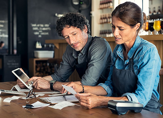 husband and wife going over financials of their business