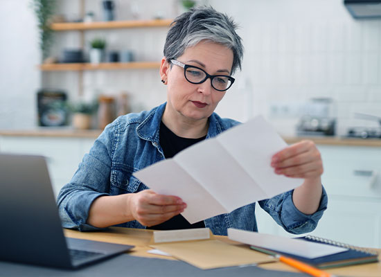 lady at a table reading her mail