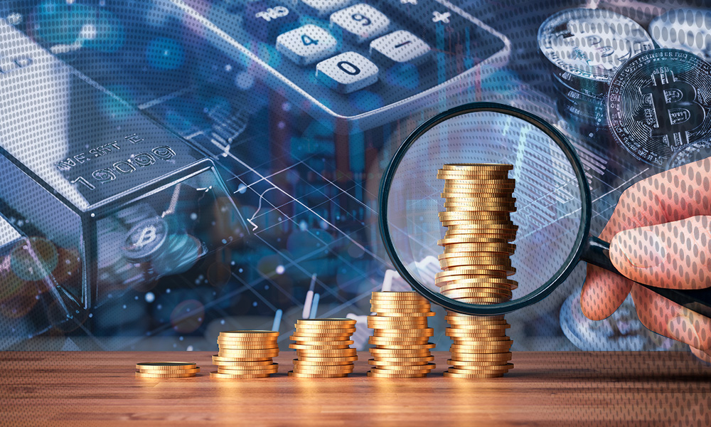 a close-up of a hand holding a magnifying glass, focusing on stacks of gold coins arranged in ascending order. In the background, there are various financial elements including a calculator, a bar of silver, and representations of Bitcoin and other cryptocurrencies, suggesting themes of investment, savings, and financial analysis.