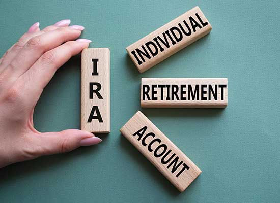 Blocks spelling out 'IRA' alongside 'Individual Retirement Account' highlight key retirement planning options for the self-employed.