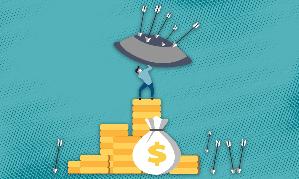 A person standing on a pile of gold coins holding a shield to protect a money bag from arrows, symbolizing investors favoring asset protection over growth.