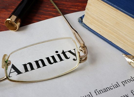 A document titled 'Annuity' on a desk, symbolizing retirement planning and guaranteed income streams.