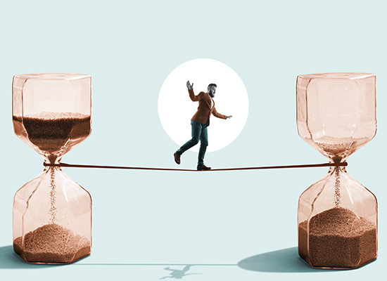 A person balancing on a tightrope suspended between two hourglasses