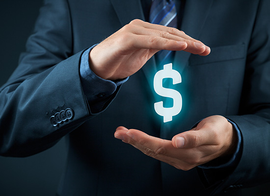 A businessperson's hands cradle a glowing dollar sign, symbolizing financial management and wealth preservation.