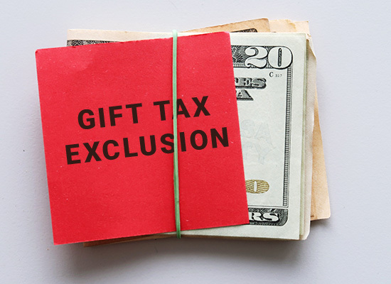 stack of money labeled gift tax exclusion