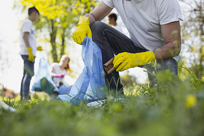 Volunteers picking up trash in park