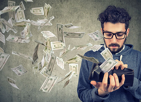 person opening wallet with cash flying out from inside it
