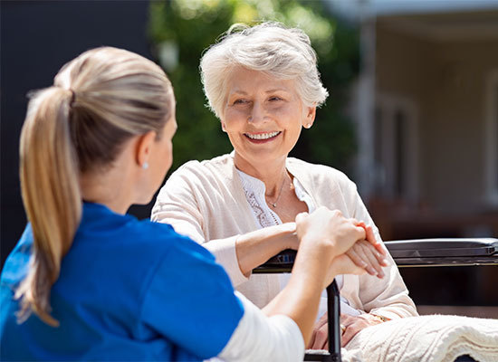healthcare worker assisting elderly woman