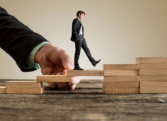 male walking on wooden blocks going upwards