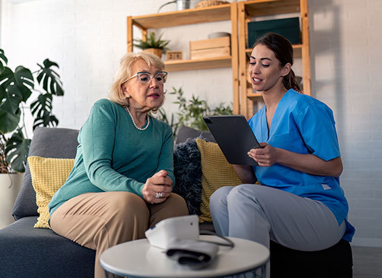 nurse consulting inside womans home