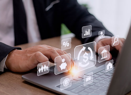 A person using a laptop with financial icons projected above the keyboard, highlighting the importance of managing retirement income and fixed income investments in the face of inflation.