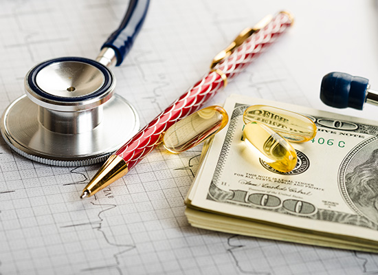 A stethoscope, pen, and supplements on top of hundred-dollar bills and a medical chart, representing HSA benefits and FSA eligible expenses.