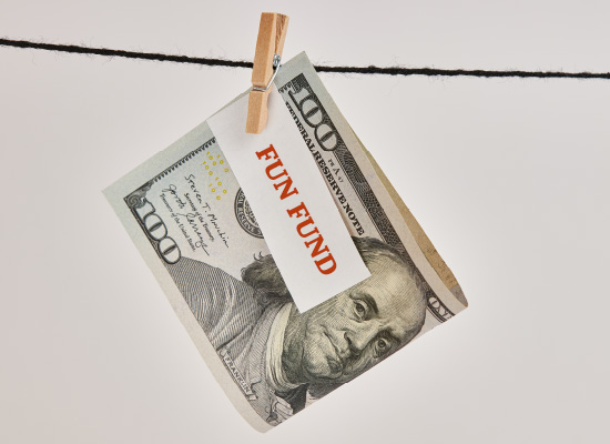 A $100 bill with 'FUN FUND' written on it is clipped to a clothesline, representing retirement savings for enjoyable activities.