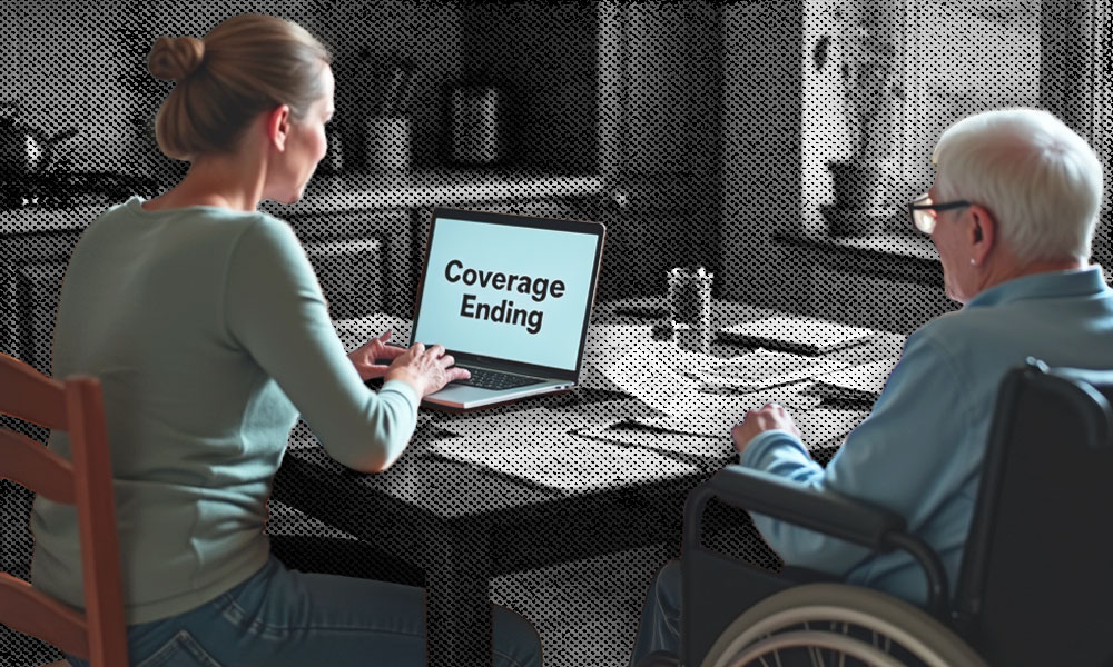 A concerned woman sits at a table with an elderly man in a wheelchair, looking at a laptop screen that reads 'Coverage Ending'