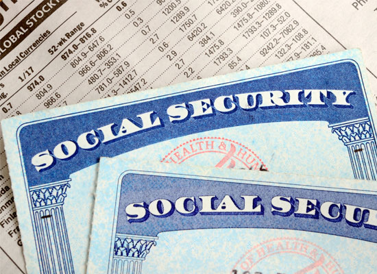Social Security cards are displayed on top of financial data, representing a key element of retirement income and retirement planning