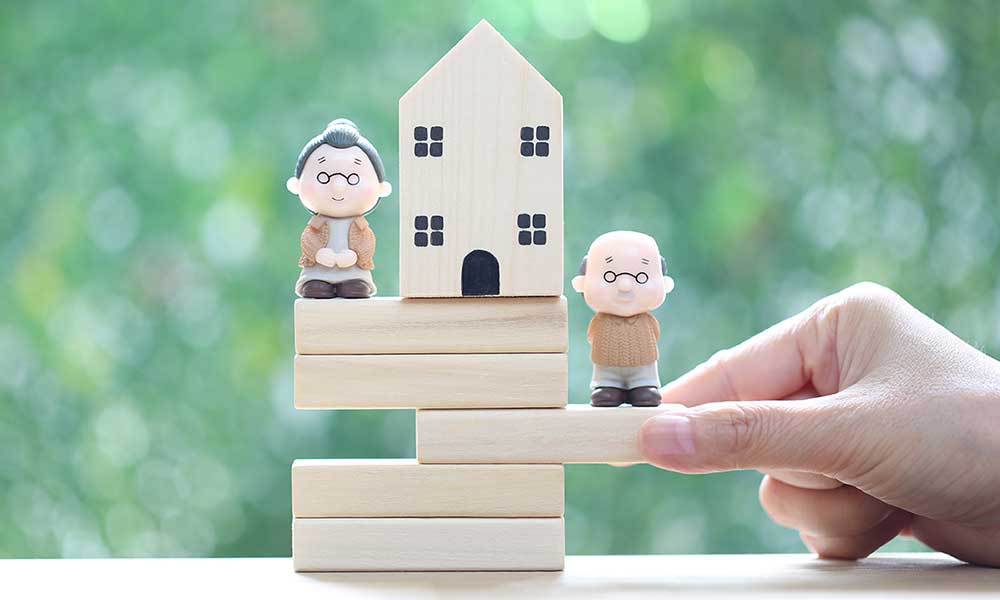 Elderly inviduals standing on blocks