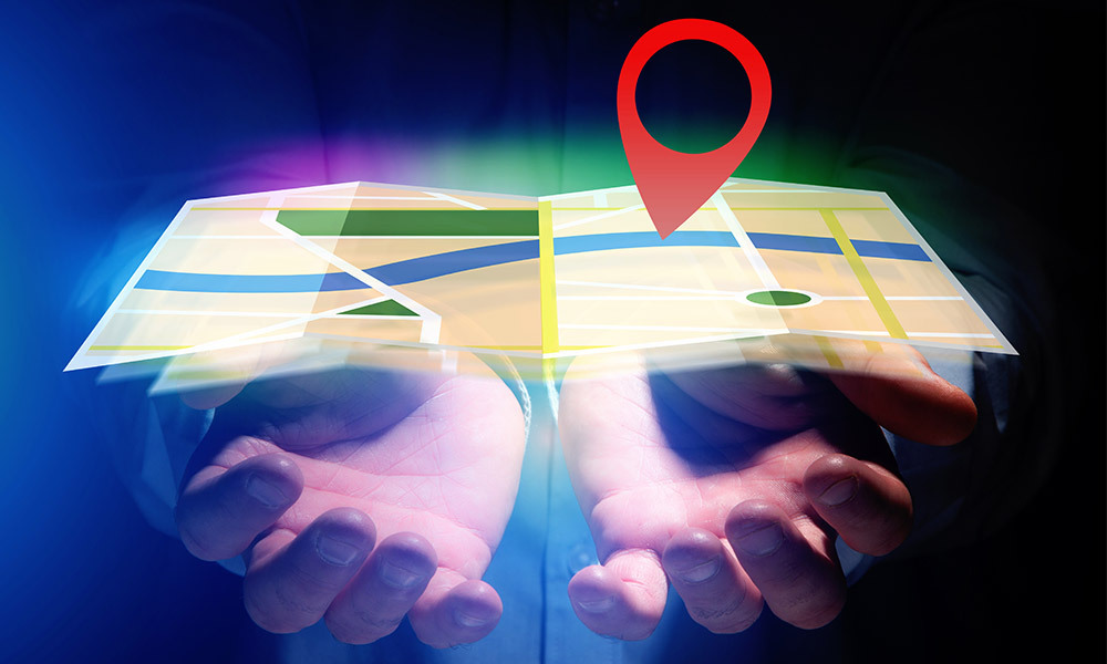 person holding hands out with a GPS map in hands