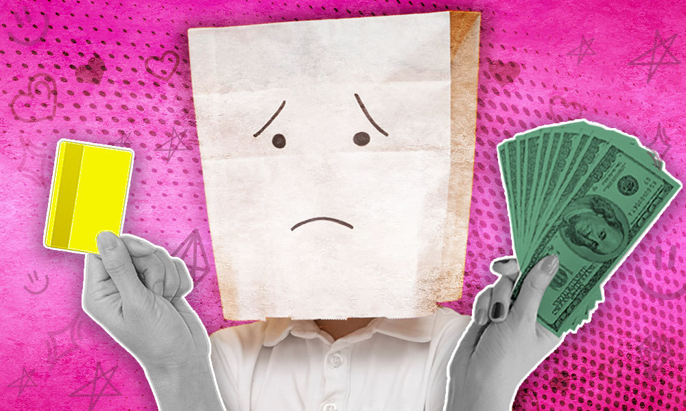 paper bag with a sad face on it looking a money and a credit card