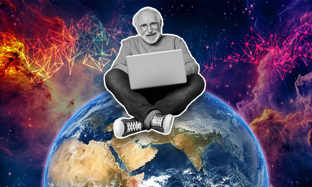 older man sitting on top of the world with a laptop