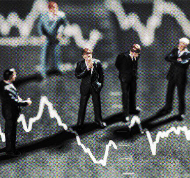 toy business people standing on a finance graph