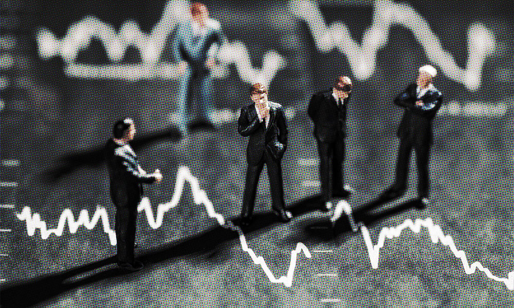 toy business people standing on a finance graph