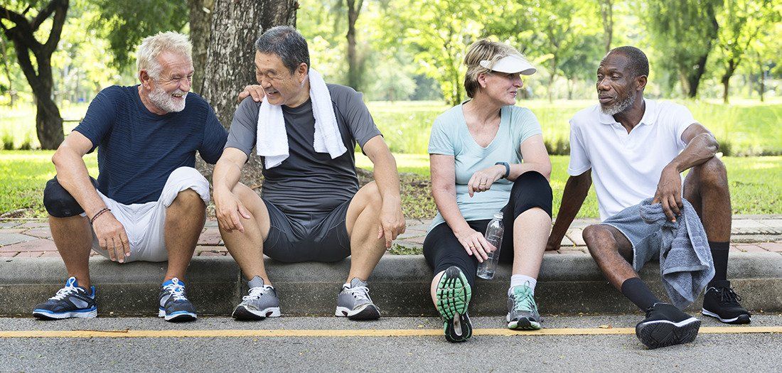 Group of older friends running, keeping fit together