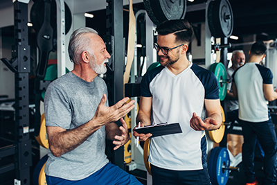 Senior man getting personal exercise training