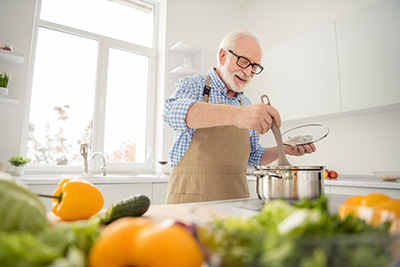 Jolly old man cooking healthy food
