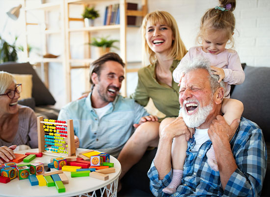 a happy family of all ages playing together while laughing