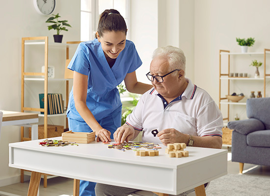 nurse assisting an elderly male
