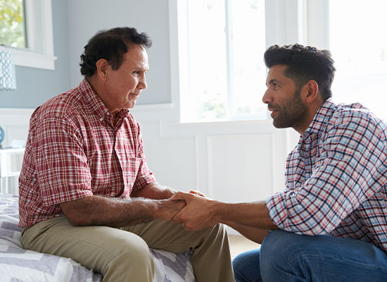 adult son comforting confused father