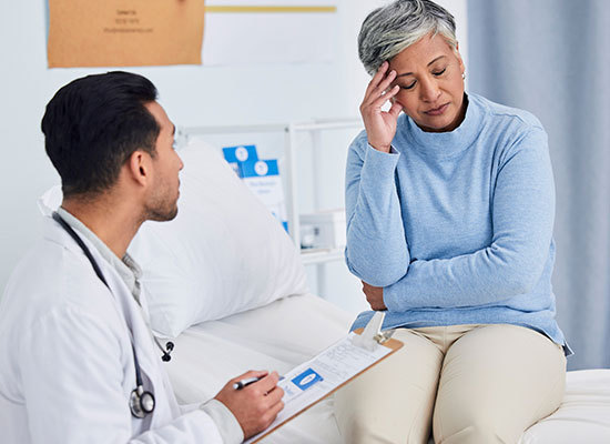 woman at doctor feeling stressed and uncomfortable
