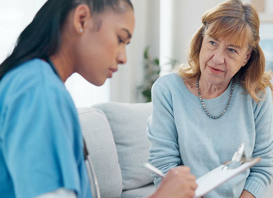 woman speaking with nurse