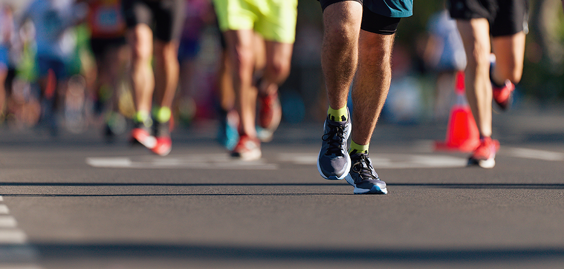 Waist down shot of runners running a marathon