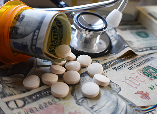 A prescription bottle spilling pills and rolled dollar bills onto scattered currency, highlighting the economic challenges of health care costs.