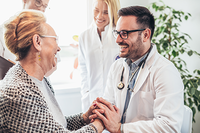 Doctor congratulates older woman for her health