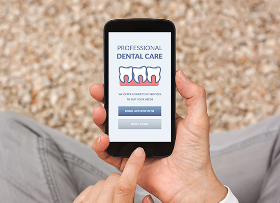 A senior is using a mobile app to book a dental appointment, highlighting the importance of accessible dental care for retirees.