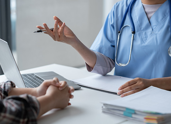 A medical professional discussing health care services with a patient highlights the value of care coordination and planning for older adults.