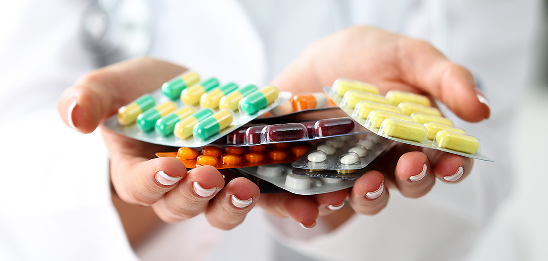 Woman holding a handful of perscription medication