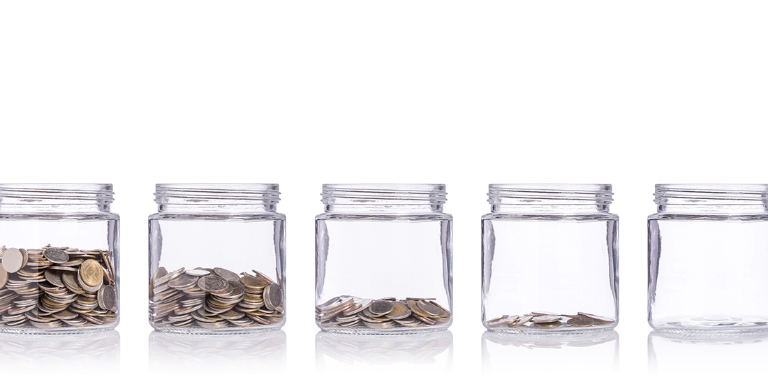 Jars of coins lined up, each with a little less 