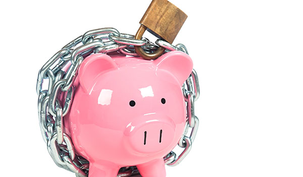 Piggy bank wrapped in chains with a sucured padlock