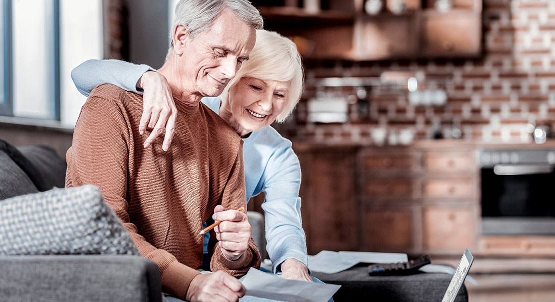 An older couple researching how to maximize their social security benefits.