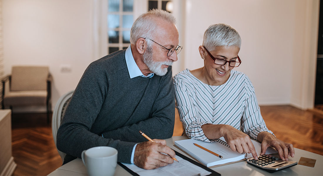 Elderly couple working on their finances