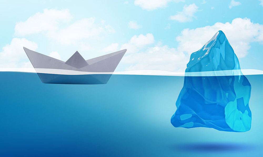 a view of a paper boat floating next to an iceberg