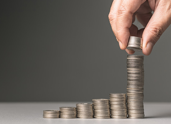 coins being stacked in steps from shortest to tallest